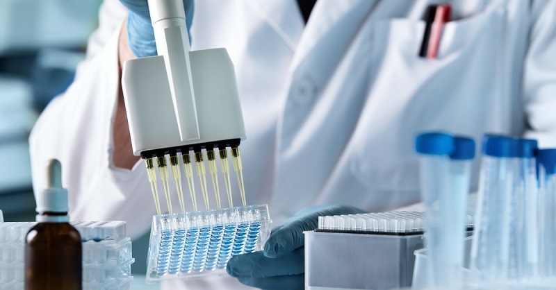 research technician with multipipette in genetic laboratory