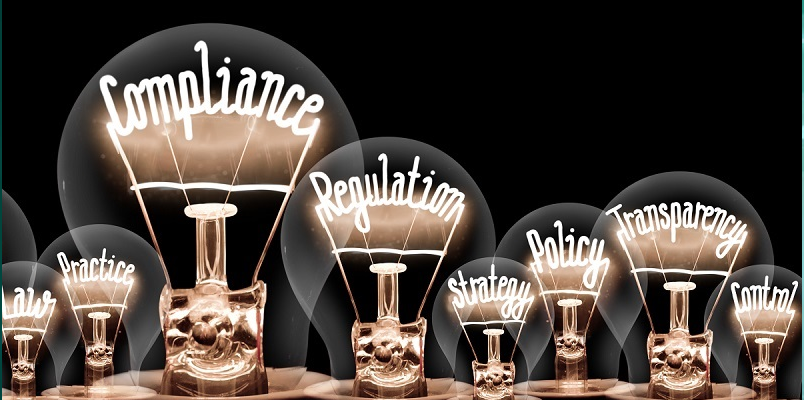 compliance regulation and other words light up in a light bulb